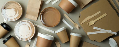 many eco and sustainable food packaging and takeout containers. kraft bowls, pizza boxes, wood cutlery, paper cups and paper bags