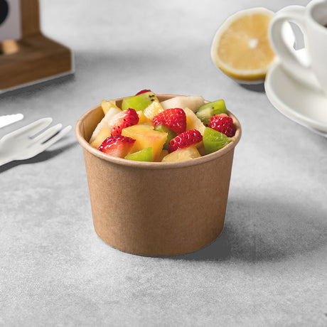 kraft paper bowl with fruit, strawberry, kiwi, orange and pear.