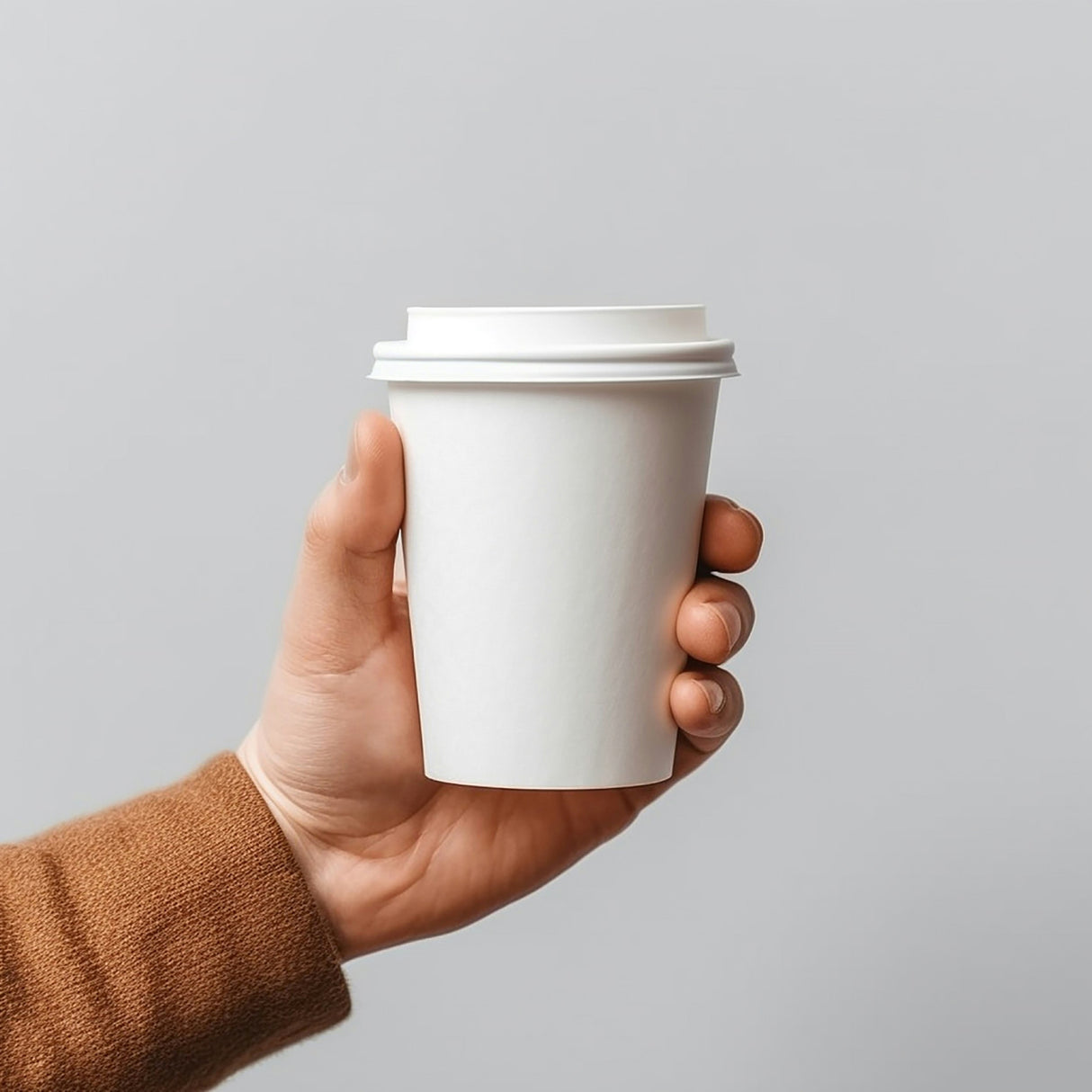 a hand is holding a 8oz white coffee cup with white lid.