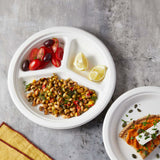 bagasse plate with lemon wedges, cherry tomato and greek salad