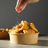 spreading salt on a bowl of chicken nuggets