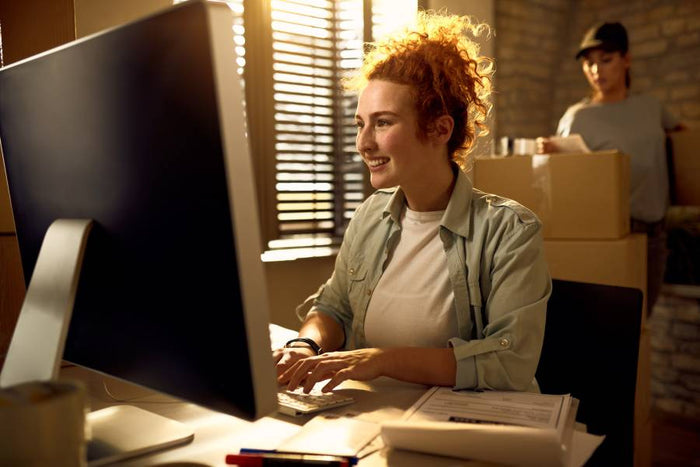 a female customer service employee typing and answering customers' questions