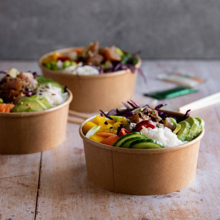 3 poke bowls using kraft paper salad bowl on wood surface