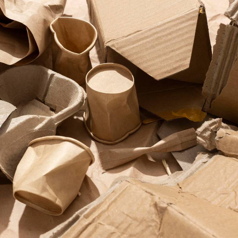 kraft paper waste, paper cups and corrugated cardboard waiting to be recycled.